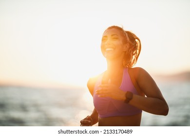 Young woman is running along the sea shore on the beach and enjoying in summer sunny day. - Powered by Shutterstock