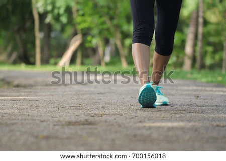Young woman running on morning outdoors in the park, fitness and healthy lifestyle concept