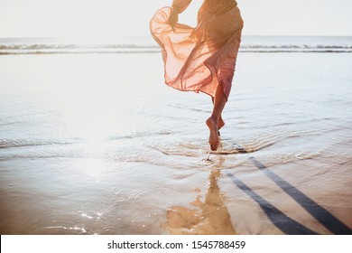 Young woman running on seaside path. summer time. - Powered by Shutterstock