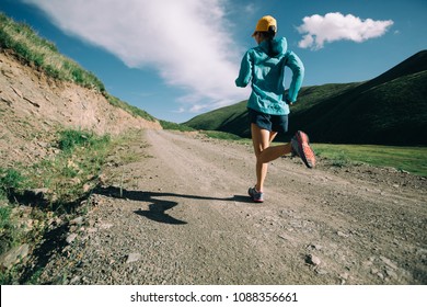 Young Woman Running On Trail