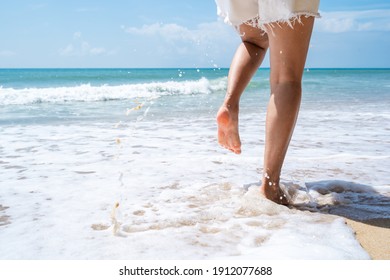 Young woman running on the tropical beach in sunny day, Summer vacation concept