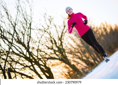 Young Woman Running Outdoors On A Cold Winter Day