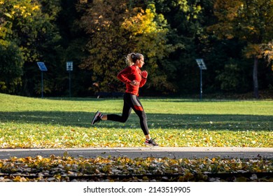 Young Woman Running In Park.