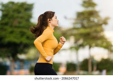 young woman running in the park in early morning - Powered by Shutterstock