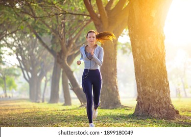young woman running in the park at  morning