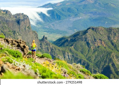 Young Woman Running Or Power Walking In Mountains On Sunny Summer Day. Beautiful Natural Landscape And Female Runner Jogging Exercising Outdoors In Nature, Rocky Trail Footpath On Canary Islands