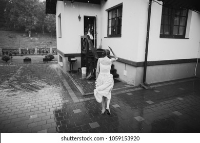 Young Woman Running In The Rain Without Umbrella