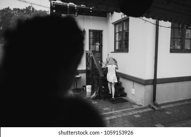 Young Woman Running In The Rain Without Umbrella