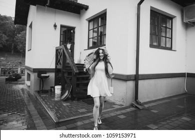 Young Woman Running In The Rain Without Umbrella