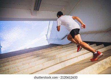 Young woman running sprinting up stairs. Fit runner fitness runner during outdoor workout. Selected focus - Powered by Shutterstock