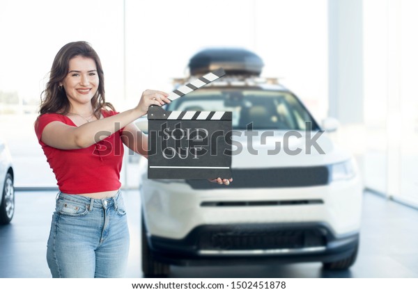 young woman sale cars at\
showroom