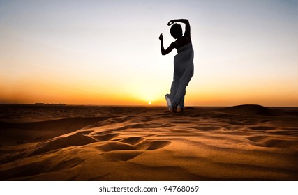 Young Woman In Sandy Desert At Sunset