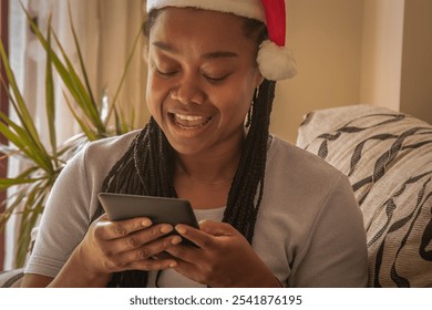 young woman with santa claus hat using digital tablet at christmas - Powered by Shutterstock