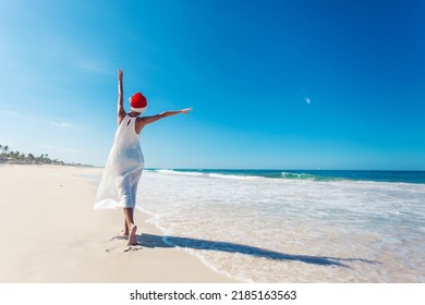 Young woman in santa hat on tropical beach. Christmas vacation. Christmas beach vacation travel woman wearing Santa hat 
 - Powered by Shutterstock