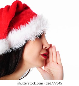 Young  Woman In Santa Hat Tells Gossip Or Secret On White Background