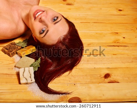 Young woman in sauna with soap. Healthy lifestyle.