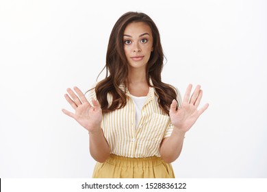 Young Woman Saying No, Dislikes Offer. Attractive Stylish Female Raise Hands In Rejection, Make Skeptical Reluctant Expression, Asking Stop, Unwilling Continue Conversation, Having Disagreement