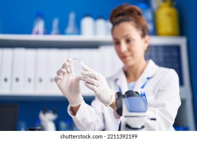 Young Woman Scientist Looking Sample Working At Laboratory