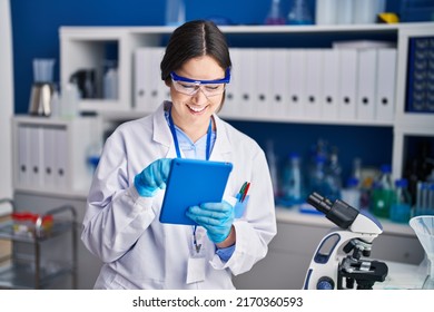 Young Woman Scientist Using Touchpad At Laboratory