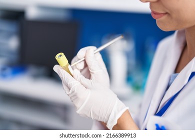 Young Woman Scientist Writing On Urine Test Tube At Laboratory