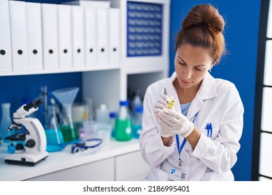 Young Woman Scientist Writing On Urine Test Tube At Laboratory