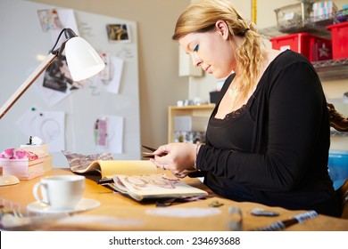 Young Woman Scrapbooking At Home