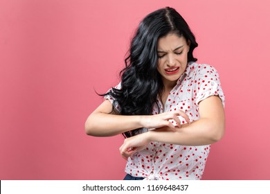 Young woman scratching her itchy arm. Skin problem. - Shutterstock ID 1169648437