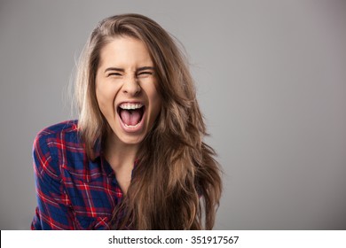 Young Woman Screaming Loudly - Studio Portrait.