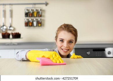 Young Woman Scrubbing The Bar In Kitchen