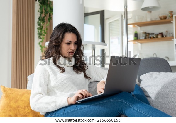 Young woman search the
internet on laptop computer ads for selling and buying cars. Woman
searches the internet in search of a reliable and affordable moving
company. 