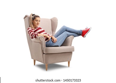 Young Woman Seated In An Armchair Watching TV Isolated On White Background
