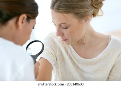 Young woman seeing doctor for dermatological control 