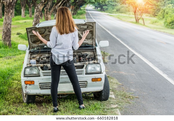 Young woman seeking help His car engine crash\
Car trouble.