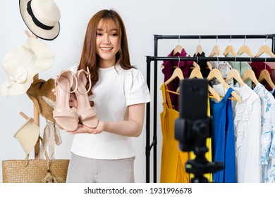 Young Woman Selling Shoes And Clothes Online By Smartphone Live Streaming, Business Online E-commerce At Home