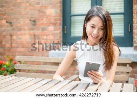 Young Woman sending message on cellphone