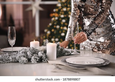 Young Woman Setting Table For Christmas Dinner At Home, Closeup