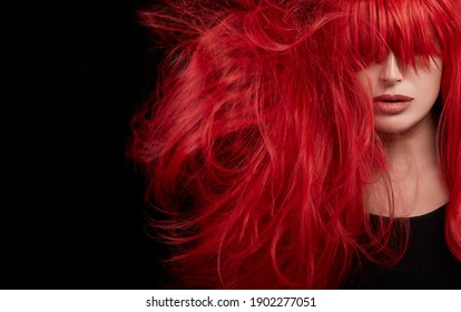 Young Woman Shaking A Healthy Long And Shiny Hair Dyed With A Professional Red Hair Color. Closeup Portrait Isolated On Black Background