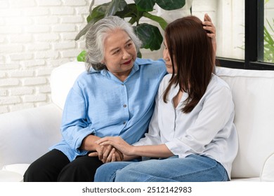 A young woman shares a heartfelt conversation with her mother on a special day, their bond evident in the warmth and affection they express toward each other. - Powered by Shutterstock