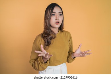 Young woman with shocked expression with as if asking why