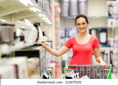 Young Woman Shopping For Appliance In Supermarket