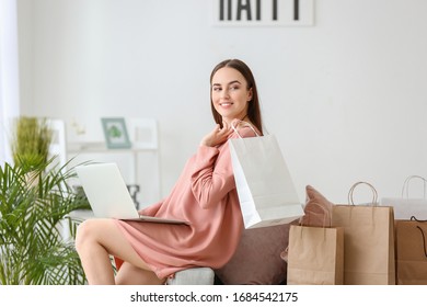 Young Woman With Shopping Bags At Home