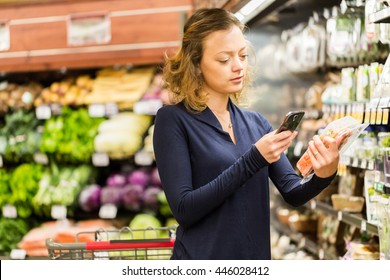 Young woman shopping in the fresh produce section at the grocery store.