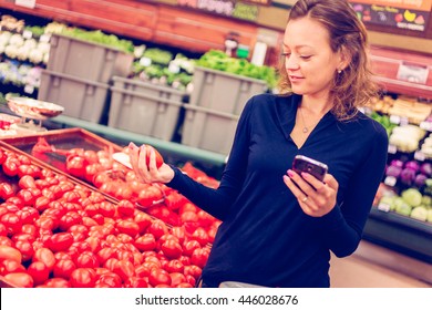 Young Woman Shopping In The Fresh Produce Section At The Grocery Store.