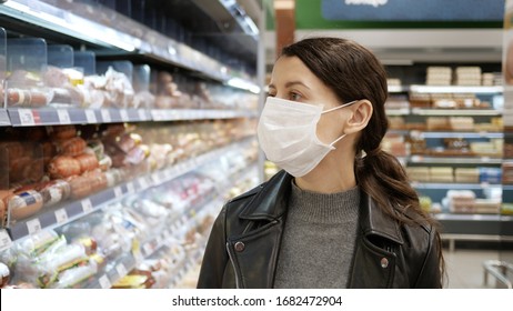 Young Woman Shopping In Grocery Store For Food While Wearing Mask And Preventing Spread Of Coronavirus Virus Germs By Wearing Face Mask.