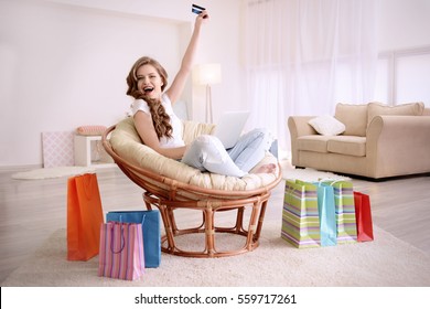Young Woman Shopping Online With Credit Card And Laptop At Home