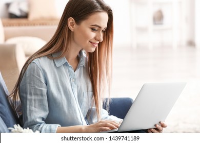 Young Woman Shopping Online At Home