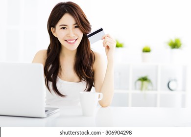 Young Woman  Shopping Online And Showing Credit Card 