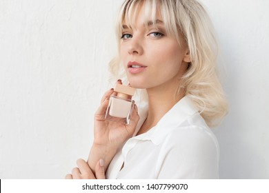 Young Woman With Short Blonde Haircut. Portrait Of Beautiful Model In White Shirt With Parfum