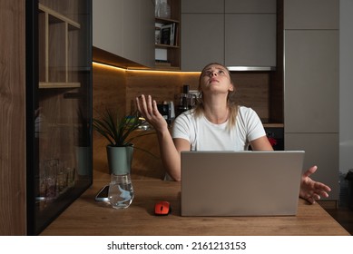 Young woman shouting trying to not to hear the loud noise from neighbor apartment in building while they renovate home and she cant work on laptop or study for school exam because of the noise - Shutterstock ID 2161213153