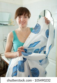 Young Woman With Shower Curtain  In Her Bathroom